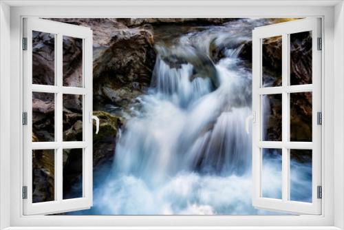 Fototapeta Naklejka Na Ścianę Okno 3D - small waterfall of a fast and crystalline mountain river, on a bedrock, long exposure with silk effect, Catalan Pyrenees, Lleida, Spain