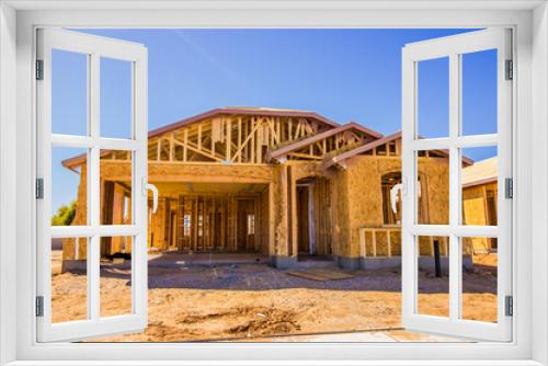 Fototapeta Naklejka Na Ścianę Okno 3D - Modern Home During Framing & Plywood Construction Phase