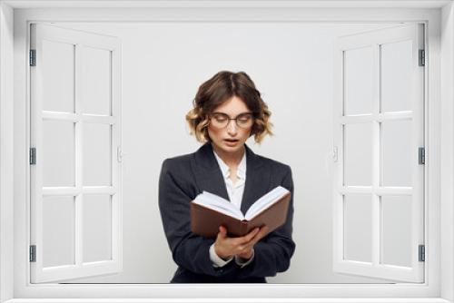 Woman in classic suit with open book glasses on face cropped view