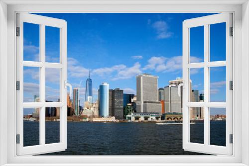 Fototapeta Naklejka Na Ścianę Okno 3D - Office buildings and skyscrapers on the coastline of  Lower Manhattan , New York, USA. sunny  day with blue sky.