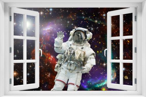 Fototapeta Naklejka Na Ścianę Okno 3D - Astronaut flies in space. The elements of this image furnished by NASA.