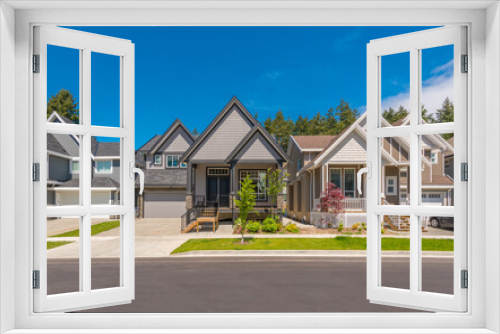 Fototapeta Naklejka Na Ścianę Okno 3D - A perfect neighbourhood. Houses in suburb at Summer in the north America. Luxury houses with nice landscape.