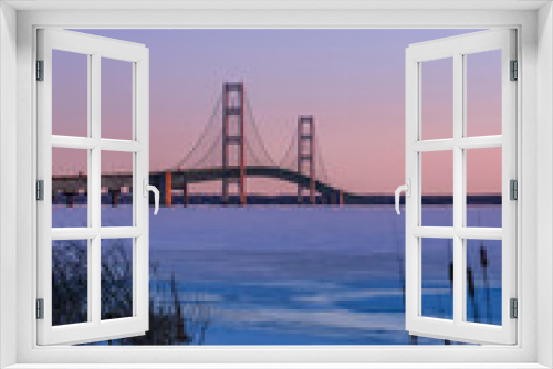 Fototapeta Naklejka Na Ścianę Okno 3D - Iconic Mackinac bridge in frozen Lake Michigan under twilight