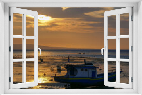 Fototapeta Naklejka Na Ścianę Okno 3D - Colorful sunset view with fishing boat on the Sawu sea at Walakiri beach near Waingapu on Sumba island, East Nusa Tenggara, Indonesia
