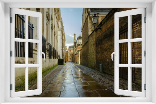 Fototapeta Naklejka Na Ścianę Okno 3D - Typical mysterious old English dark street after rain in Cambridge. 