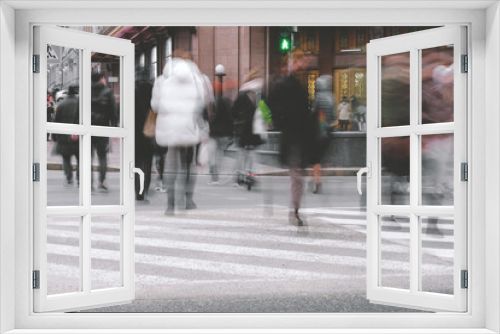 People, in motion running, on a large city street, a pedestrian crossing. Lifestyle