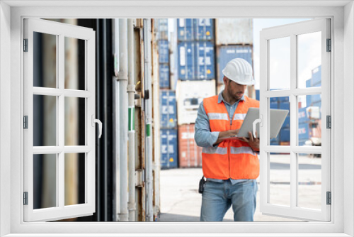 Smart Engineer or supervisor checking and control loading Containers box from Cargo at harbor.Foreman control Industrial Container Cargo freight ship at industry.Transportation and logistic concept.