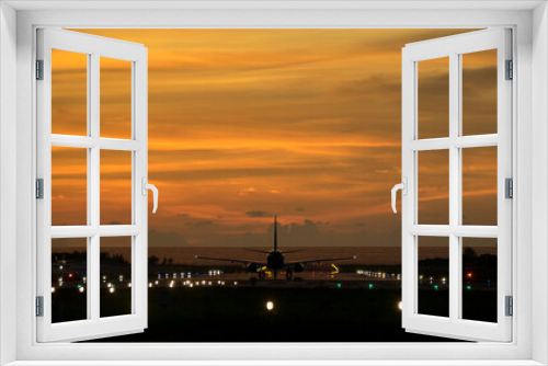 Fototapeta Naklejka Na Ścianę Okno 3D - An airplane will take-off at an airport during sunset sky   