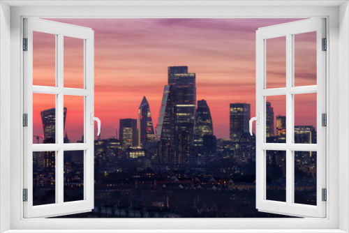 Fototapeta Naklejka Na Ścianę Okno 3D - The modern skyline of the financial district City of London, United Kingdom, during dusk with a red and orange colored sky