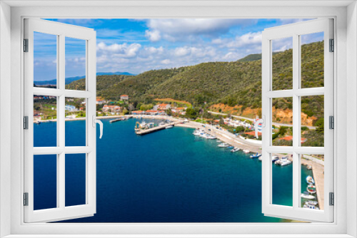 Fototapeta Naklejka Na Ścianę Okno 3D - European country village on Mediterranean sea shore with coastline pier for fishing boats. Small resort town with holiday villas along green forest hills summer background