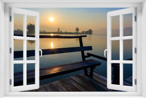 Fototapeta Naklejka Na Ścianę Okno 3D - Wooden seat or bench on the wooden bridge on the lake with Sunrise time.
