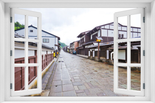 Fototapeta Naklejka Na Ścianę Okno 3D - Suwamachi Street is a road that runs through the northwestern part of Yatsuomachi in Toyama City, Toyama Prefecture. The street is lined with beautiful houses that feature tiled roofs.