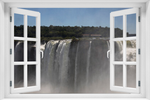 Fototapeta Naklejka Na Ścianę Okno 3D - Natural world wonder. View of the Iguazu falls seen from Garganta del Diablo, in the frontier between Argentina and Brazil. The waterfalls falling white water texture and mist in the tropical forest.