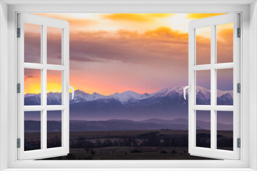 Fototapeta Naklejka Na Ścianę Okno 3D - Dramatic early sunrise landscape over carpathian mountains range covered in snow with beautiful orange sky and clouds