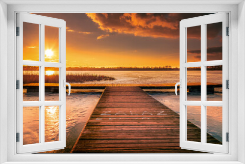 Fototapeta Naklejka Na Ścianę Okno 3D - beautiful, fabulous sunset over the frozen lake and the pier - Lake Rotcze