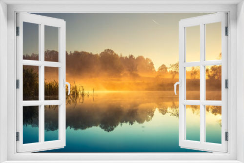 Fototapeta Naklejka Na Ścianę Okno 3D - A beautiful river morning with mist and sun light. Springtime scenery of river banks in Northern Europe. Warm, colorful look.