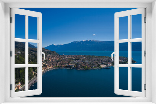 Fototapeta Naklejka Na Ścianę Okno 3D - Panoramic view of the historic city of Toscolano Maderno on Lake Garda Italy. Aerial view of the town on Lake Garda. Tourist place on Lake Garda in the background Alps and blue sky.