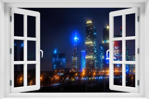 Fototapeta Naklejka Na Ścianę Okno 3D - Moscow-city at night in the rain in the fog and at low clouds. High quality photo