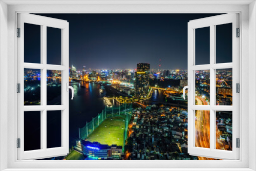 Fototapeta Naklejka Na Ścianę Okno 3D - Aerial view of Ho Chi Minh city, Vietnam. Beauty skyscrapers along river light smooth down urban development. Dramatic lighting spectacular night.