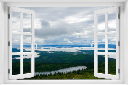 Fototapeta Naklejka Na Ścianę Okno 3D - View from the highest point near Arjeplog in Sweden. This view is towards the lake Hornavan in Sweden, in Norrbotten County - Lapland. One of the many wetlands in Sweden.