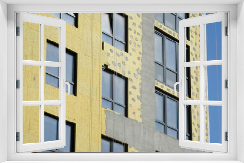 Fototapeta Naklejka Na Ścianę Okno 3D - Thermal insulation of an apartment building and plastering of walls.