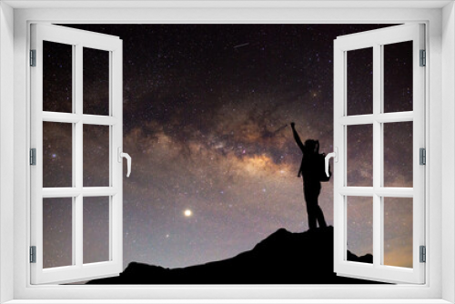 Fototapeta Naklejka Na Ścianę Okno 3D - Milky Way. Night sky with stars and silhouette of a standing Mountaineer man with yellow light on the mountain. Space background