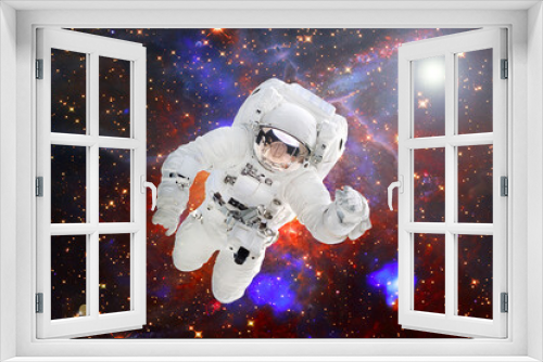 Fototapeta Naklejka Na Ścianę Okno 3D - Astronaut against deep space. The elements of this image furnished by NASA.