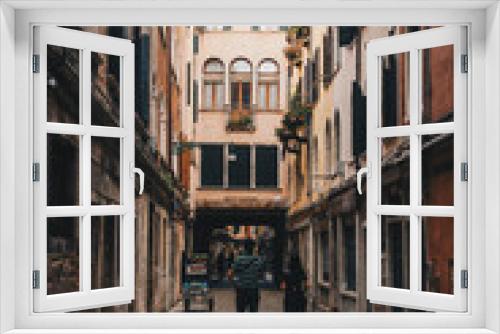 Fototapeta Naklejka Na Ścianę Okno 3D - The italian street with beautiful buildings and people around. Film effect and author processing of photo.