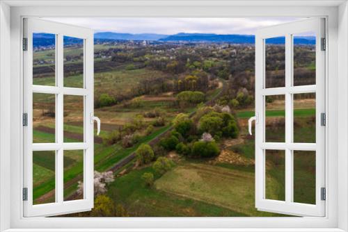 Fototapeta Naklejka Na Ścianę Okno 3D - Panoramic view of the mountain village, the Carpathian village in Ukraine, roads and agricultural fields.