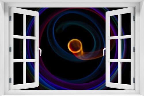Fototapeta Naklejka Na Ścianę Okno 3D - Abstract rotating neon lights texture with black empty copy space inside. colored rainbow rays in a circle and in a frame, on a black background, they are spinning multi-colored