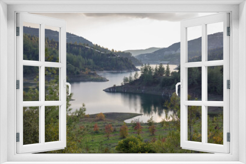 Fototapeta Naklejka Na Ścianę Okno 3D - Beautiful landscape with mountains and lake. Turquoise water and beautiful autumn trees with yellow leaves and coniferous forests. Cyprus