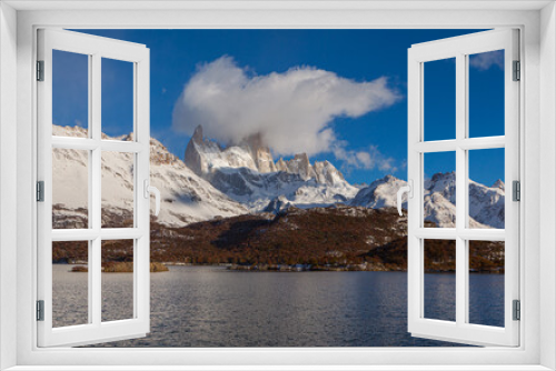 Fototapeta Naklejka Na Ścianę Okno 3D - Panorama image of  a mountain range with the summit of the Cerro Fitzroy shrouded in clouds with the lake 'Laguna Capri' in the foreground
