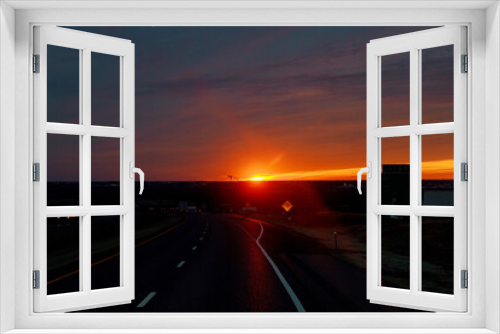 Fototapeta Naklejka Na Ścianę Okno 3D - Country road with cloudy sky in the light of the dawn sunset