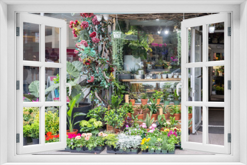 Fototapeta Naklejka Na Ścianę Okno 3D - Small local flower store with many plants and flowers creating outside display