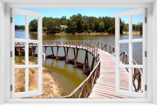 Fototapeta Naklejka Na Ścianę Okno 3D - Wooden walkway bridge on the reservoir in the park Built for tourism in Thailand..