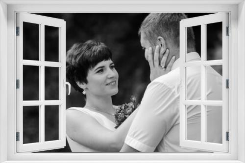 The bride and groom stand against the background of a waterfall. Newlyweds on the background of a waterfall