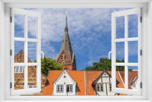 Fototapeta Naklejka Na Ścianę Okno 3D - Church tower over roofs of old houses in Flensburg, Germany