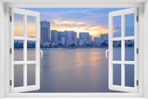 Fototapeta Naklejka Na Ścianę Okno 3D - Photo done by the author in Ho Chi Minh City, Vietnam. Time: evening on April 27, 2021. When the sunset comes, the author noticed that the color of the sky has a huge change, the photo of the architec