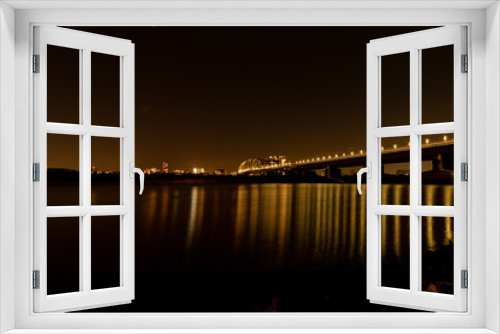 Fototapeta Naklejka Na Ścianę Okno 3D - Night wide city view of Nijmegen. Bridge at night, reflection in the water