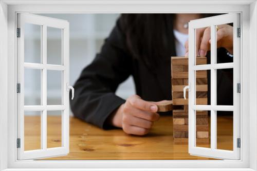 Fototapeta Naklejka Na Ścianę Okno 3D - Arrange the wooden blocks stacked on the table. Construction business risk concepts For a successful business growth process