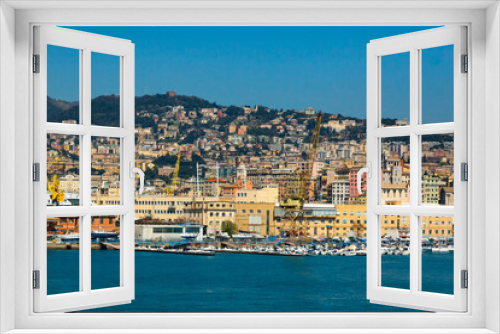 Fototapeta Naklejka Na Ścianę Okno 3D - Scenic view of the maritime city of Genoa in Italy. View from the sea to the Italian city of Genoa, beautiful colorful houses along the coast, harbor cranes and yachts moored at the pier.
