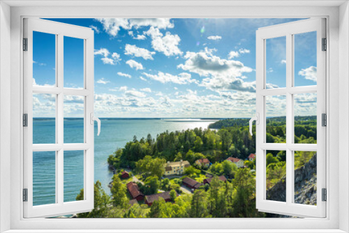 Fototapeta Naklejka Na Ścianę Okno 3D - Beautiful nature coast landscape view. Buildings surrounded with green trees on lake surface and blue sky background. Sweden.