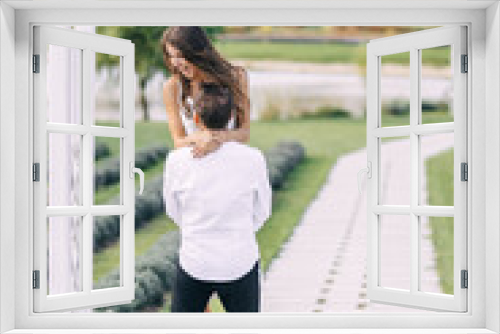 Beautiful wedding couple in nature in boho style. European-style wedding, a man whirls the bride in the garden.