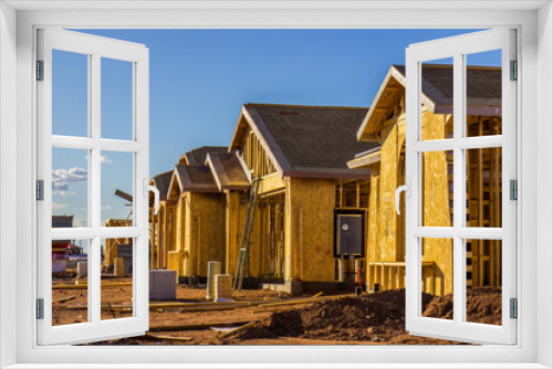 Fototapeta Naklejka Na Ścianę Okno 3D - Row Of Homes In Framing Stage Of Construction
