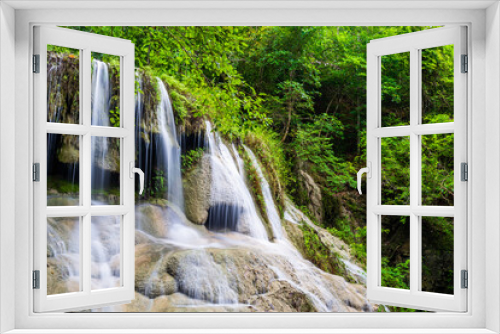 Fototapeta Naklejka Na Ścianę Okno 3D - Waterfall and blue emerald water color in Erawan national park. Erawan Waterfall, Beautiful nature rock waterfall steps in tropical rainforest at Kanchanaburi province, Thailand