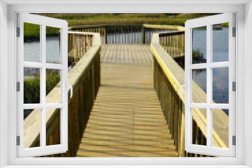 Fototapeta Naklejka Na Ścianę Okno 3D - A wooden walkway over the marsh in Folly Beach SC, just south of Charleston