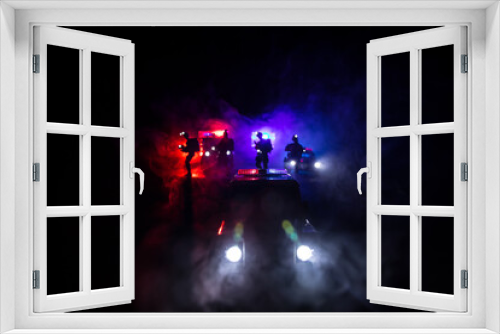 Fototapeta Naklejka Na Ścianę Okno 3D - Police cars at night. Police car chasing a car at night with fog background. 911 Emergency response police car speeding to scene of crime.