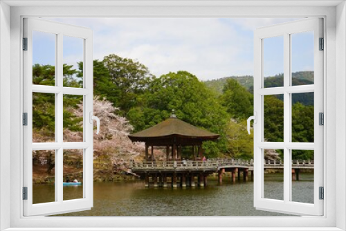 Fototapeta Naklejka Na Ścianę Okno 3D - Ukimido Pavilion on Sagi-ike pond with Sakura, Cherry Blossoms, in Nara park, Japan, isolated - 日本 奈良 奈良公園 春の桜 浮見堂 