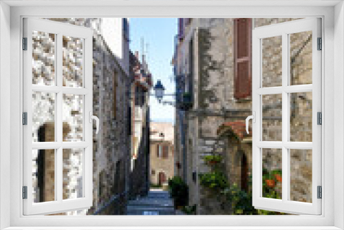 Fototapeta Naklejka Na Ścianę Okno 3D - A street between old medieval stone buildings of Bassiano, historic town in Lazio region, Italy.