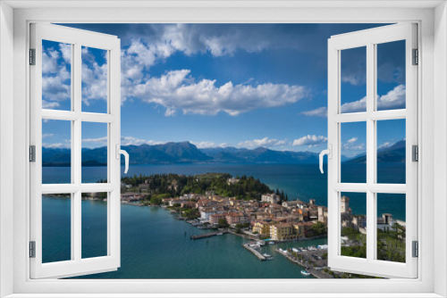 Fototapeta Naklejka Na Ścianę Okno 3D - Sirmione, Lake Garda, Italy. Panorama of Lake Garda. Castle on the water in Italy. Peninsula on a mountain lake in the background of the alps. Aerial view of the island of Sirmione.